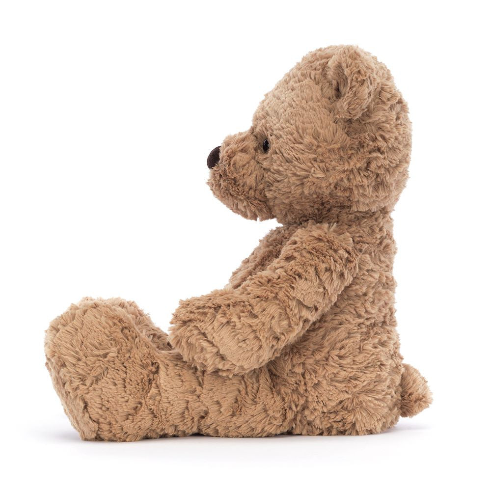 Side profile of Bumbly Bear Medium by JellyCat, displaying its cuddly form and charming appearance.