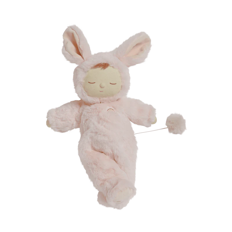 The Lullaby Cozy Dinkums Bunny Moppet by Olli Ella displayed lying down, highlighting its soft pink fur and charming design.